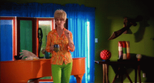 a person wearing green pants stands in a brightly colored room