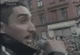 a man's face is overlaid with white paint and a blurry city scene