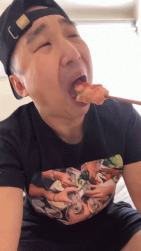 a person sitting with food in his mouth