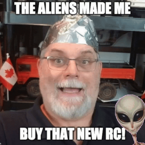a man with white hair wearing a silver foil hat