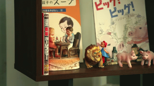a shelf containing some fake figurines and children's books