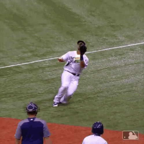 a baseball player is running through a field
