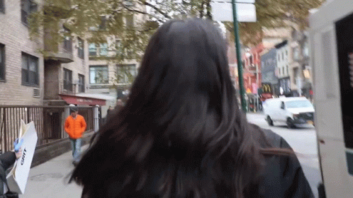a person walking down the street with long hair