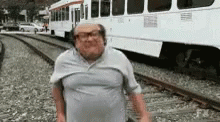 a blurry image of an old man next to a trolley car