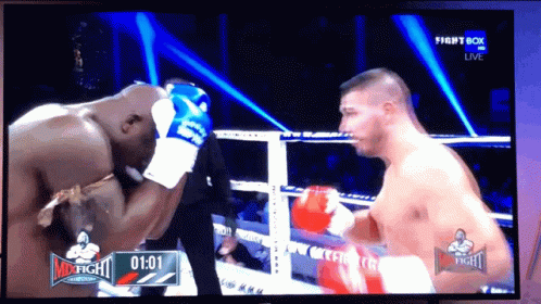 two men in the middle of a boxing match
