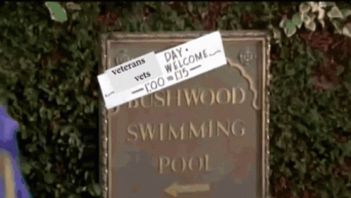 a sign with a couple of stickers stuck to it that reads'dry wood swimming pool, vero beach '