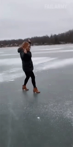 a young lady is walking on the ice