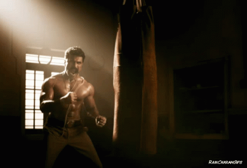 a man stands in a dark room with punching punchings
