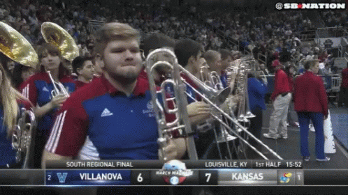 a band and marching players are seen on television
