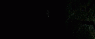 the woman is sitting in the dark alone