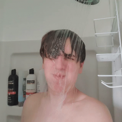 man in shower getting soaked with soapy shampoo