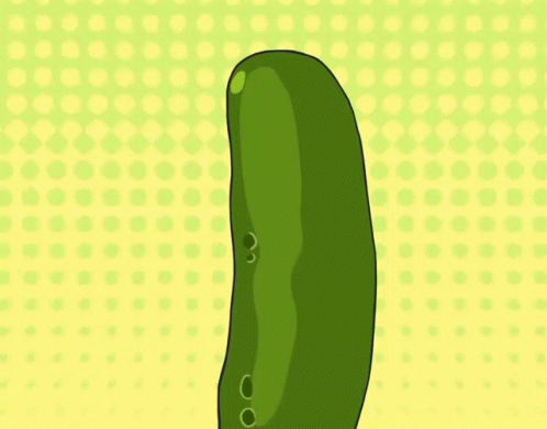 a green pickle standing on top of a green plate