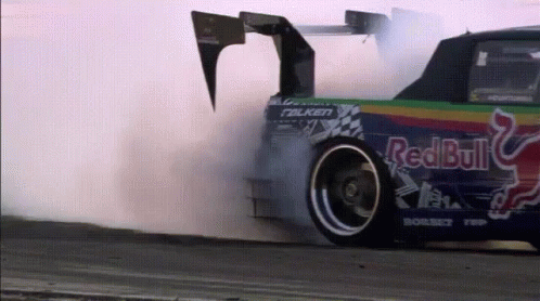 an antique race car spins through the air in an awkward position