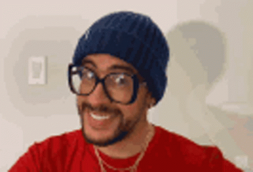 a guy with glasses and a brown knit hat