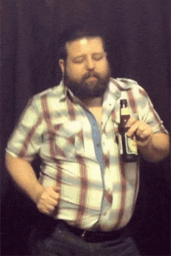 a man in plaid shirt holding up a bottle