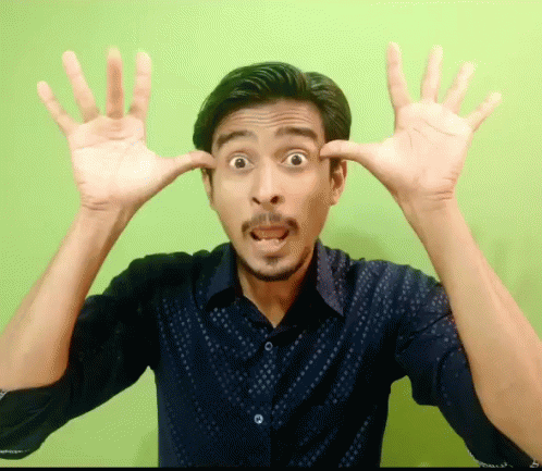 a man making a funny face with two fingers
