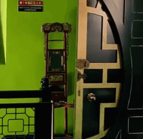 a very tall green door in a room