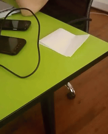a laptop computer sitting on top of a green table