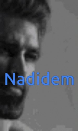 a man looks down at his cell phone and the word naddem is spelled over him
