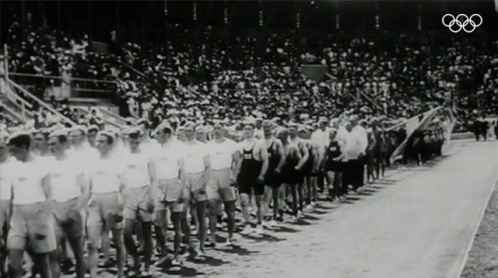 group of men standing in front of a crowd in front of a large crowd