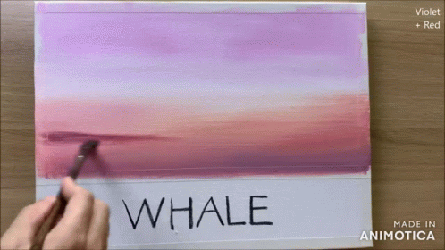a hand holding an empty paper with the word whale underneath it