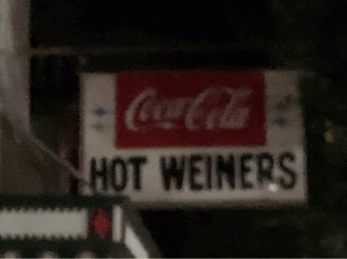 the street sign for  wieners with a cola cola sign in front