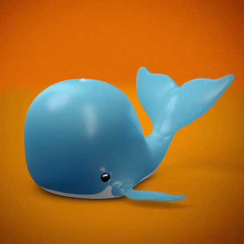 an odd looking yellow plastic whale on blue background