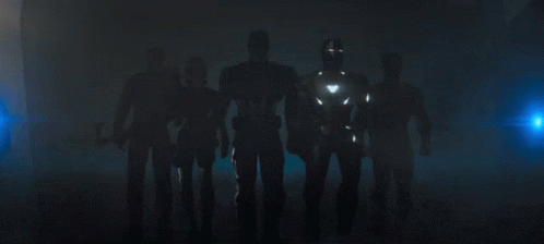 several iron men standing next to each other with their arms around each other