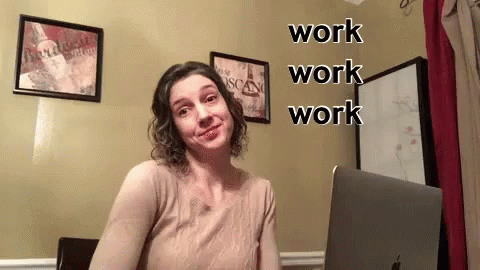 woman holding laptop computer with large, funny text that reads work work work