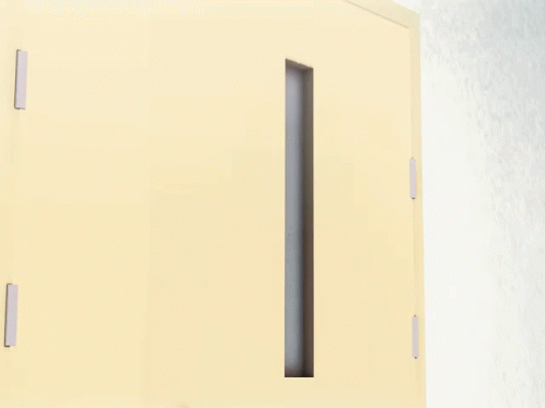 an open white cabinet door with a black handle