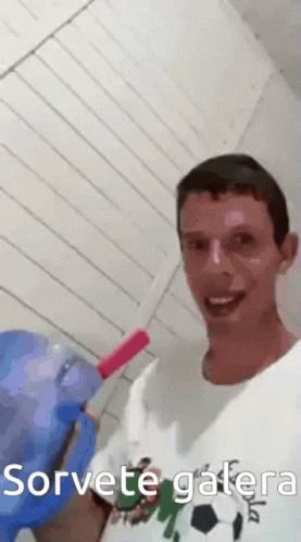 a man holding a toothbrush over his face