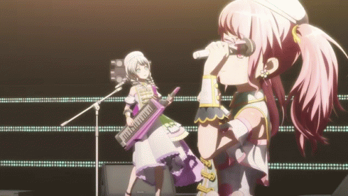two anime characters standing on stage playing an instrument