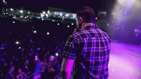 a guy that is standing up in front of a crowd