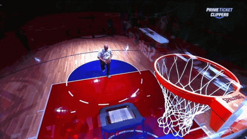 a basketball game being played with a blue and red court