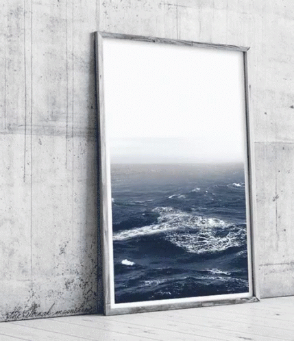 an open picture frame next to an ocean view