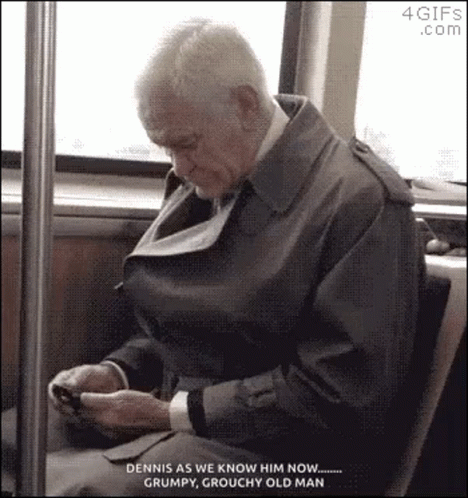 old man texting on his cell phone while riding the bus