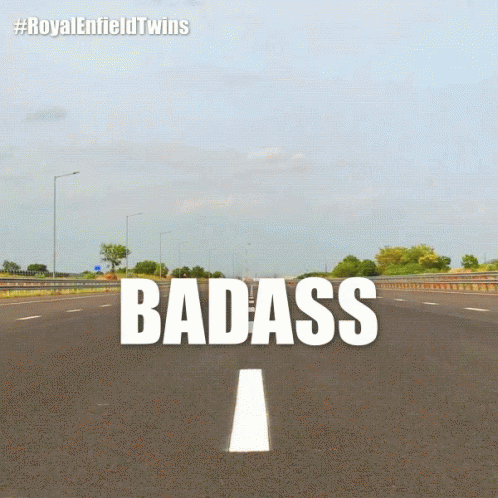 a sign that says badass on the side of a road