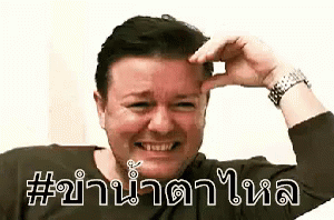 an asian guy smiles and raises his arm with the words thai on it