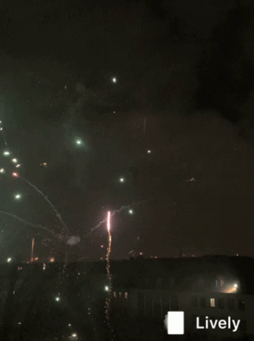 fireworks are flying over the city at night time
