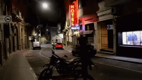 a motorcycle is parked on the street at night