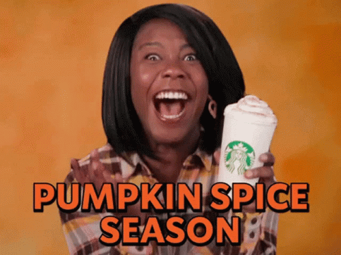a woman holding a starbucks cup and saying pumpkin spice season