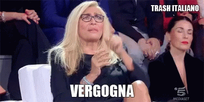 a lady is sitting next to an ad with the name vergonga