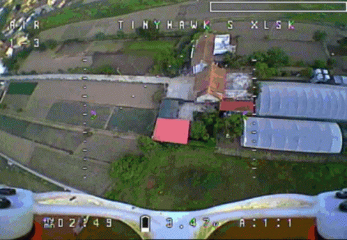 an aerial view of a small plane landing over a town