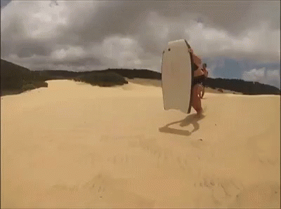 a man with a surfboard on the beach