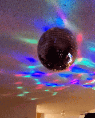the disco ball is on the ceiling with light from the ceiling