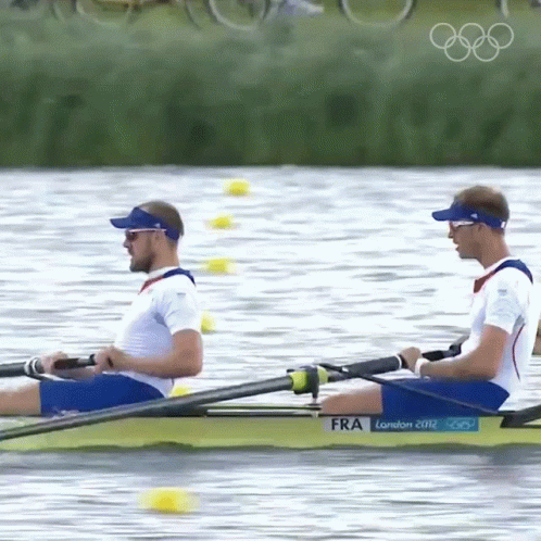 two men in matching rowing suits in the water