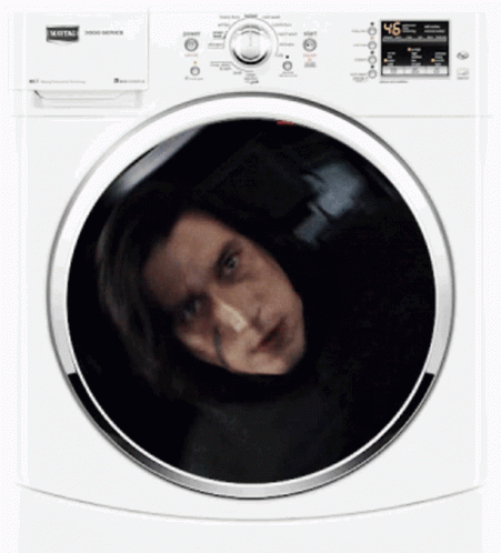 a woman is smiling inside of the front of a white appliance