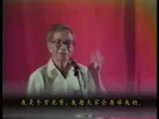 an older man giving a talk in a blue stage