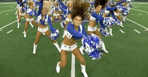a group of cheerleaders on a football field