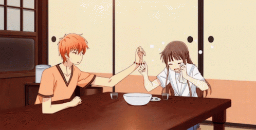 two anime characters sitting at a table